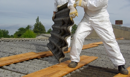Men removing asbestos roofing tiles